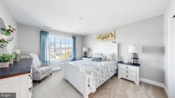 a bedroom with a bed and a potted plant