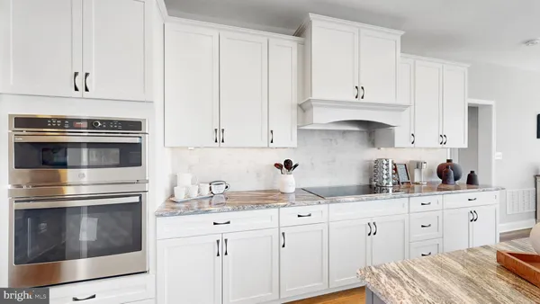a kitchen with cabinets appliances and a sink