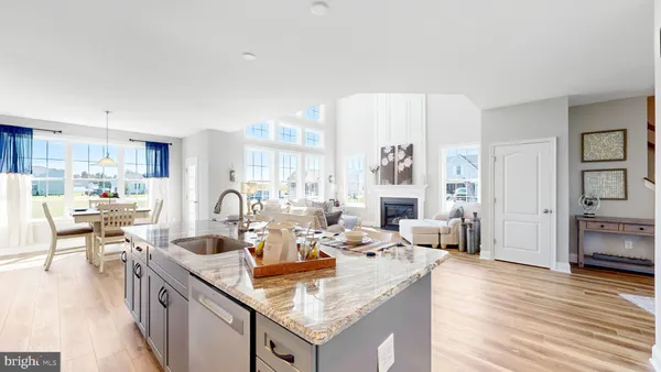 a kitchen with granite countertop a sink stove and cabinets