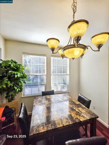 a view of a room with a table and chairs