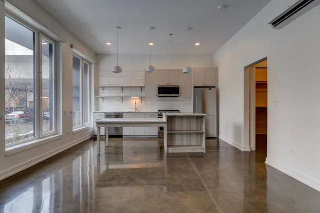 a view of kitchen with refrigerator and window