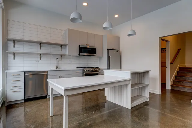 a kitchen with a sink cabinets and appliances