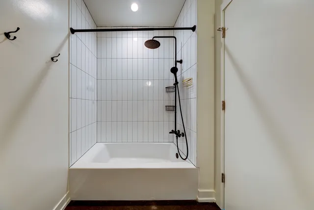 a bathroom with a shower and a bath tub