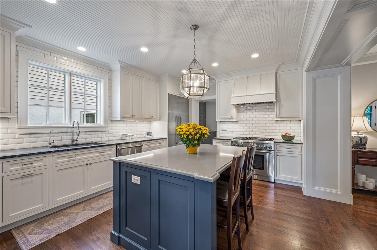 1503 Edgewood Lane Winnetka, IL 60093 - Photo 11 of 46 a kitchen with stainless steel appliances granite countertop a sink stove and wooden floor