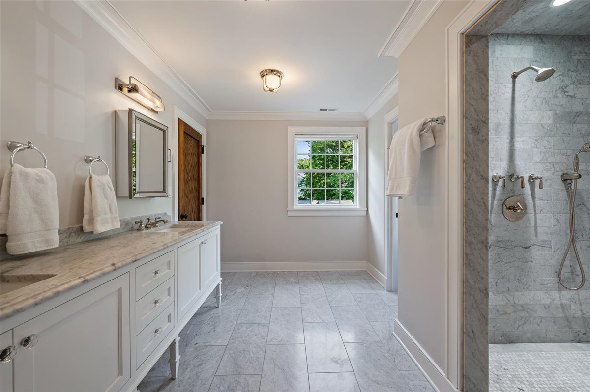 1503 Edgewood Lane Winnetka, IL 60093 - Photo 23 of 46 a spacious bathroom with a granite countertop sink a mirror and a shower