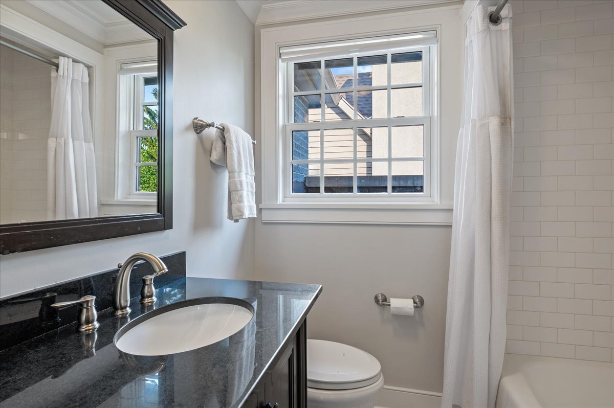 1503 Edgewood Lane Winnetka, IL 60093 - Photo 32 of 46 a bathroom with a granite countertop toilet a sink and a mirror