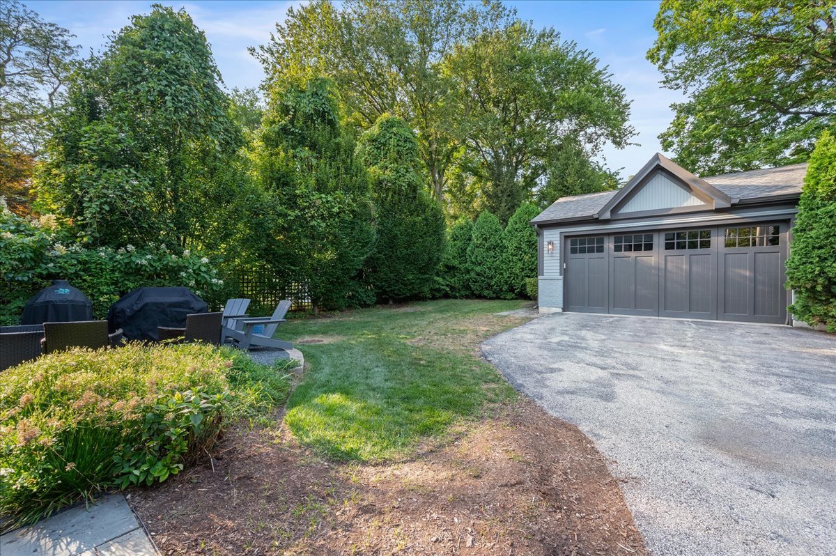 1503 Edgewood Lane Winnetka, IL 60093 - Photo 38 of 46 a front view of a house with a yard and shrubs