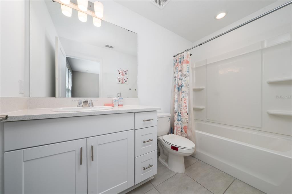 2060 Viewfinder Street Kissimmee, FL 34758 - Photo 14 of 23 a bathroom with a double vanity sink mirror and toilet