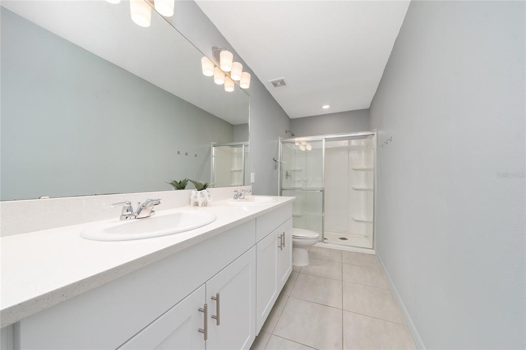 2060 Viewfinder Street Kissimmee, FL 34758 - Photo 17 of 23 a bathroom with a sink a toilet and a mirror