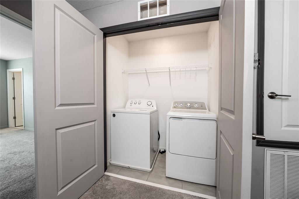 2060 Viewfinder Street Kissimmee, FL 34758 - Photo 19 of 23 a white refrigerator freezer and a stove sitting inside of a cabinet