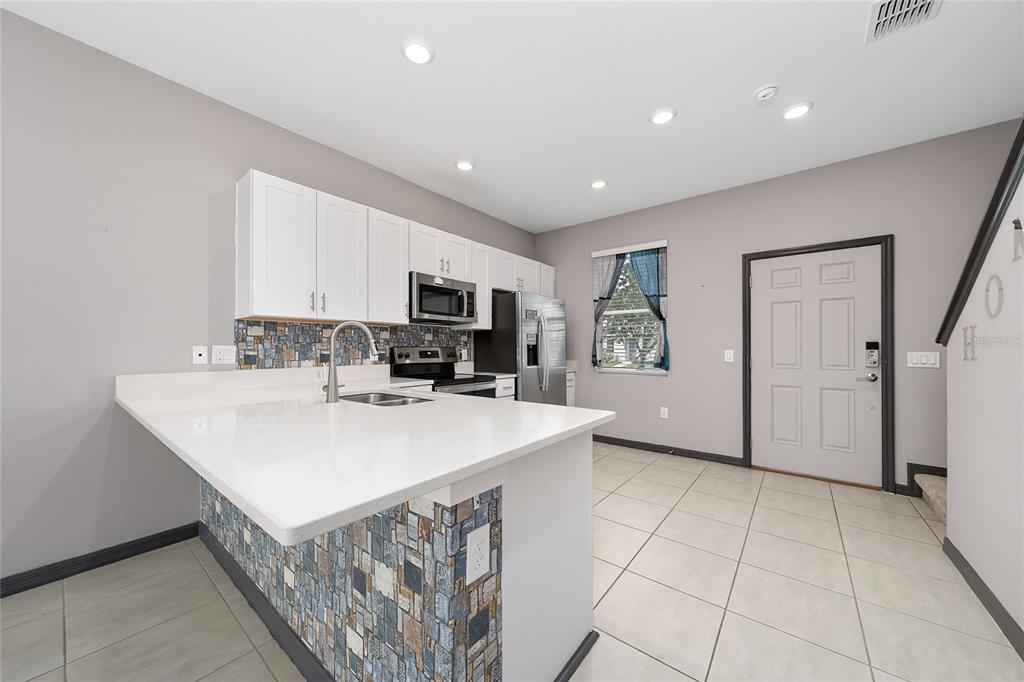 2060 Viewfinder Street Kissimmee, FL 34758 - Photo 9 of 23 a view of kitchen with sink microwave and refrigerator