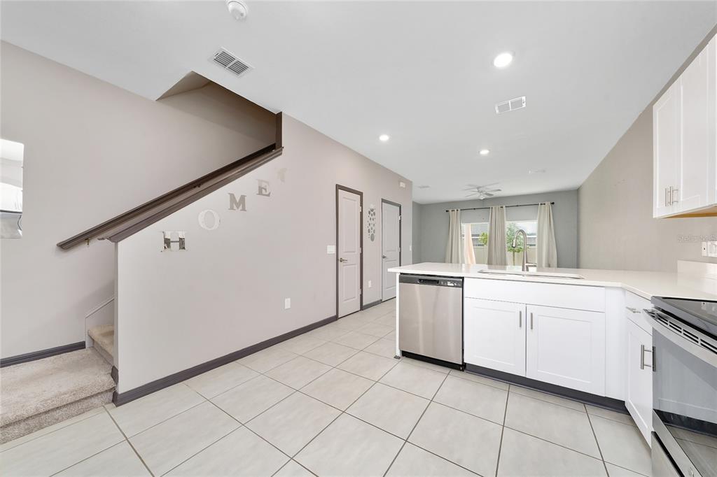 2060 Viewfinder Street Kissimmee, FL 34758 - Photo 10 of 23 a kitchen with white cabinets and white appliances