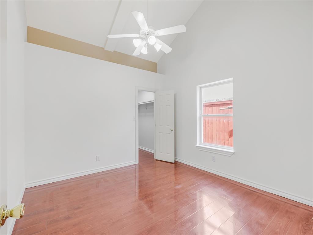 1716 East Parker Road Plano, TX 75074 - Photo 16 of 25 Room featuring vaulted ceilings with a ceiling fan, wood-finish flooring, and a window with white trim