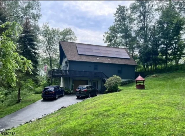a view of a house with backyard and sitting area