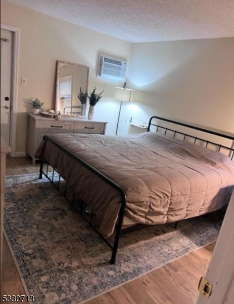 12 Ravine Road Wantage, NJ 07461 - Photo 15 of 19 a bedroom with a bed and wooden floor