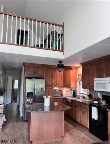 a kitchen with counter top space a sink cabinets and appliances