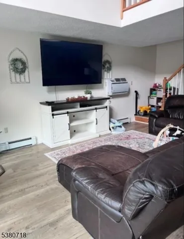 a living room with stainless steel appliances granite countertop a stove and a sink
