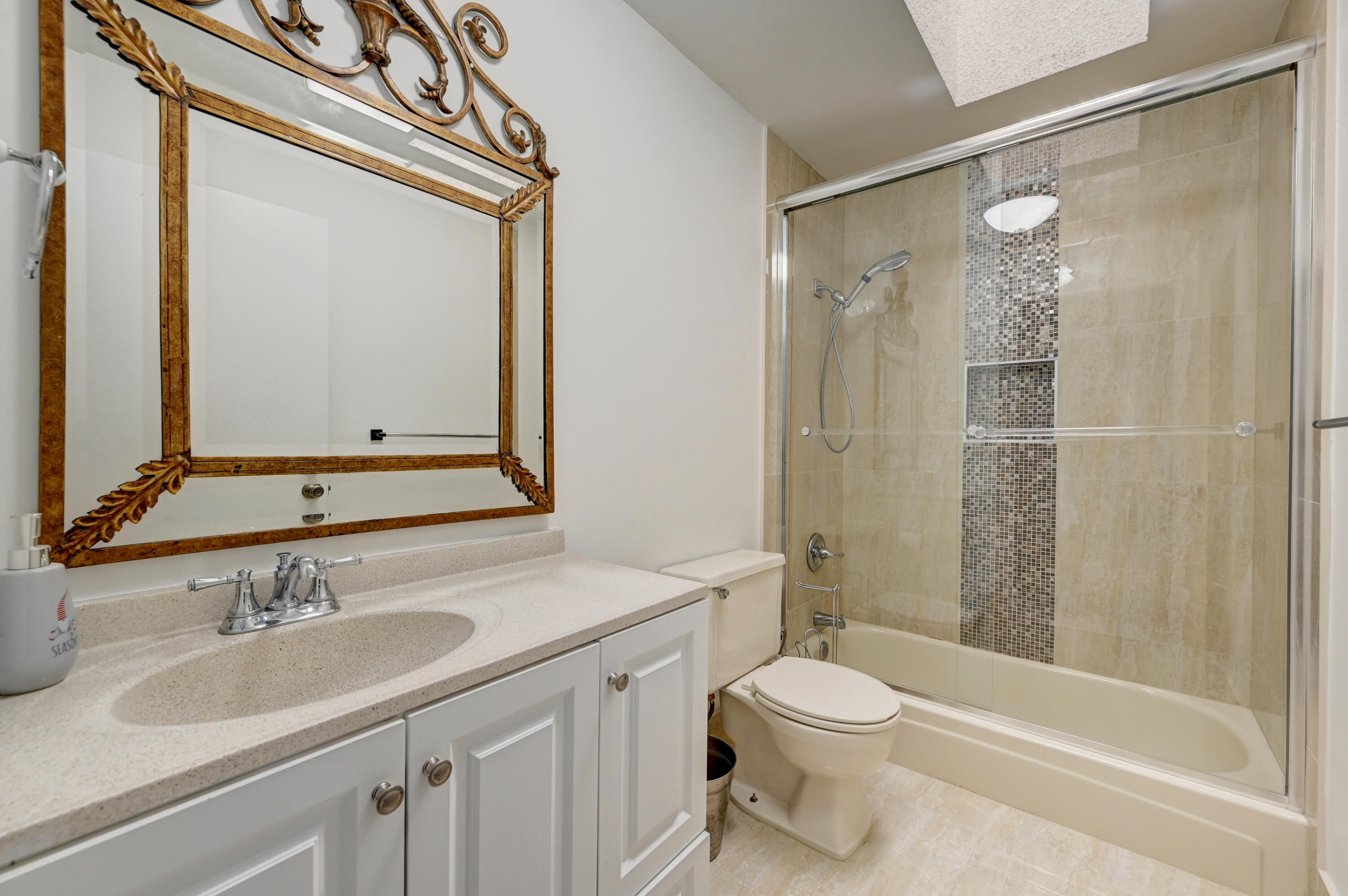 23328 Southwest 58th Avenue, Unit C Boca Raton, FL 33428 - Photo 16 of 35 a bathroom with a sink a toilet and shower