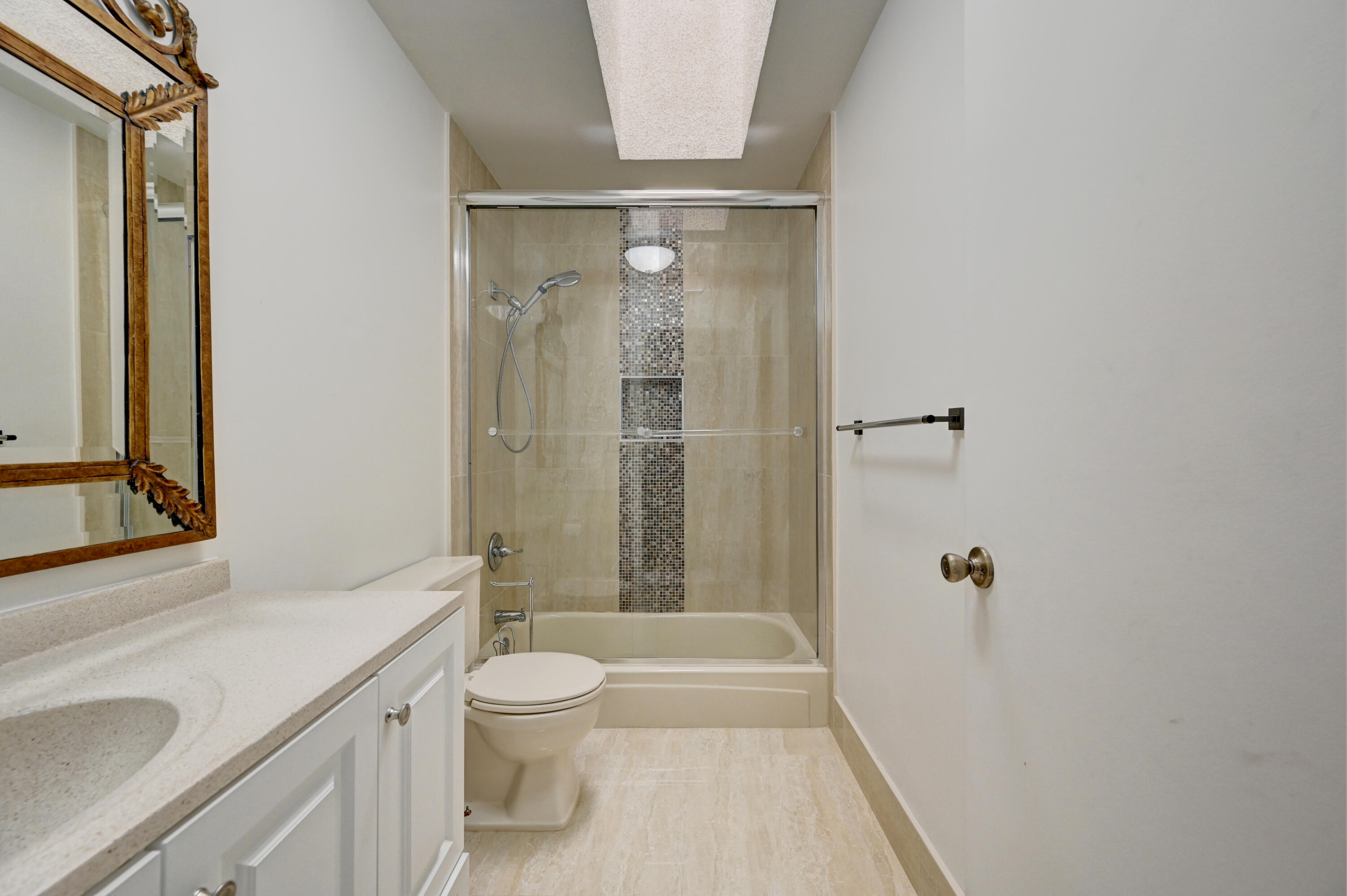 23328 Southwest 58th Avenue, Unit C Boca Raton, FL 33428 - Photo 17 of 35 a bathroom with a granite countertop sink a toilet and shower