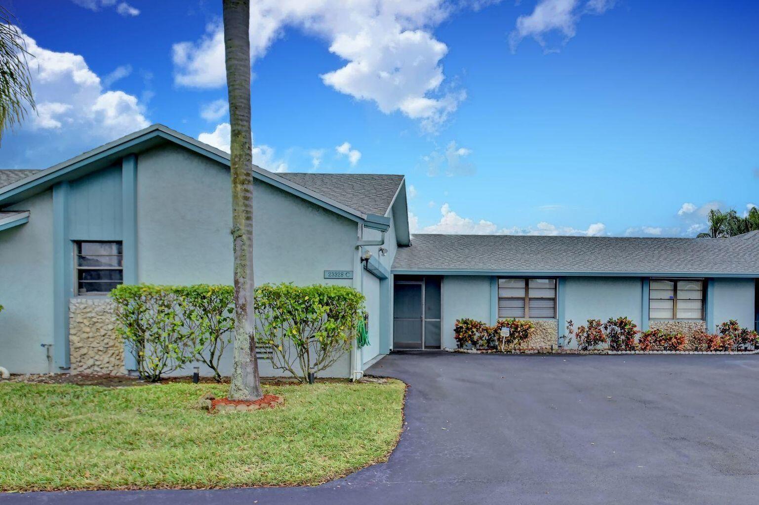23328 Southwest 58th Avenue, Unit C Boca Raton, FL 33428 - Photo 2 of 35 a front view of a house with garden