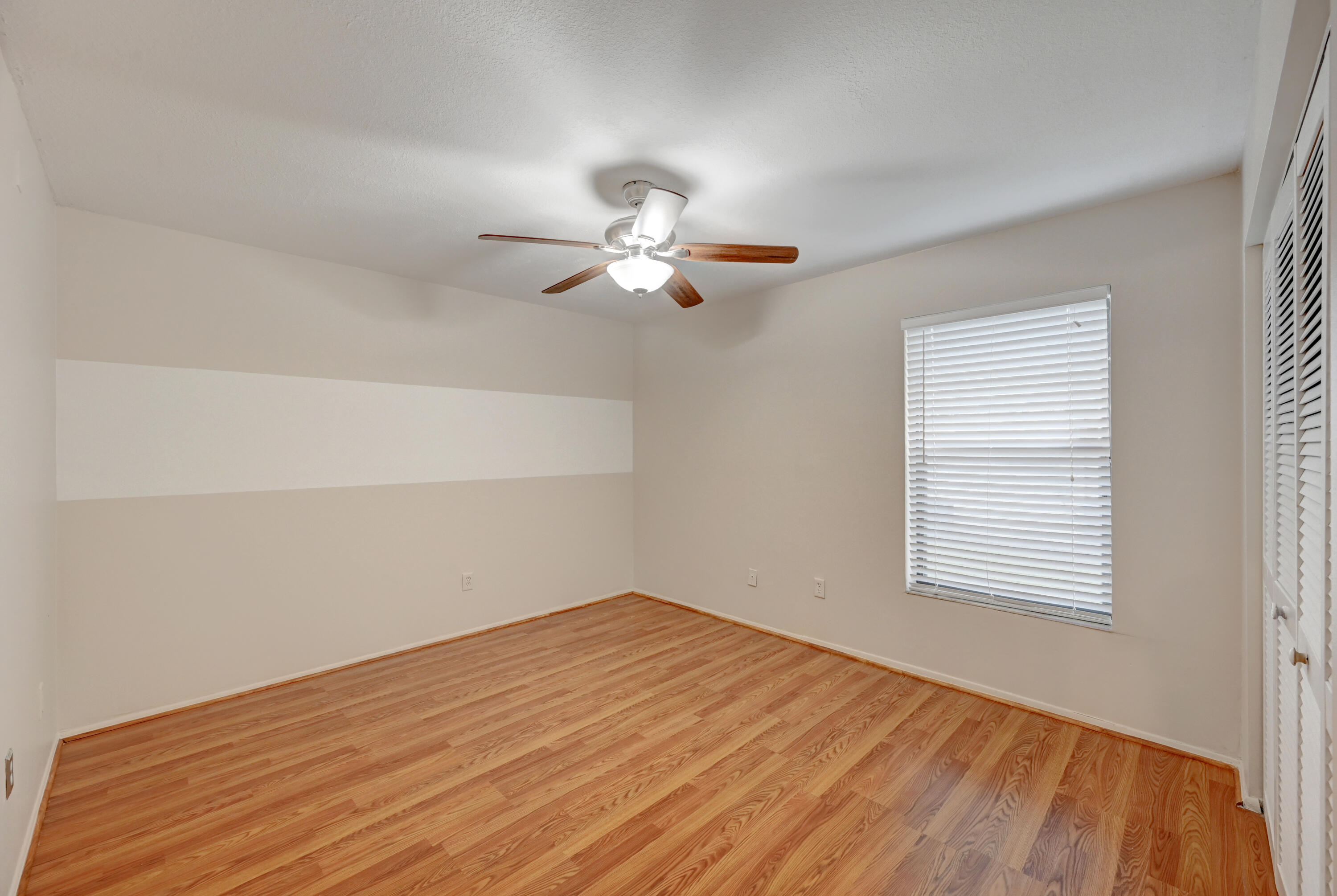 23328 Southwest 58th Avenue, Unit C Boca Raton, FL 33428 - Photo 21 of 35 a view of a room with a ceiling fan and a window