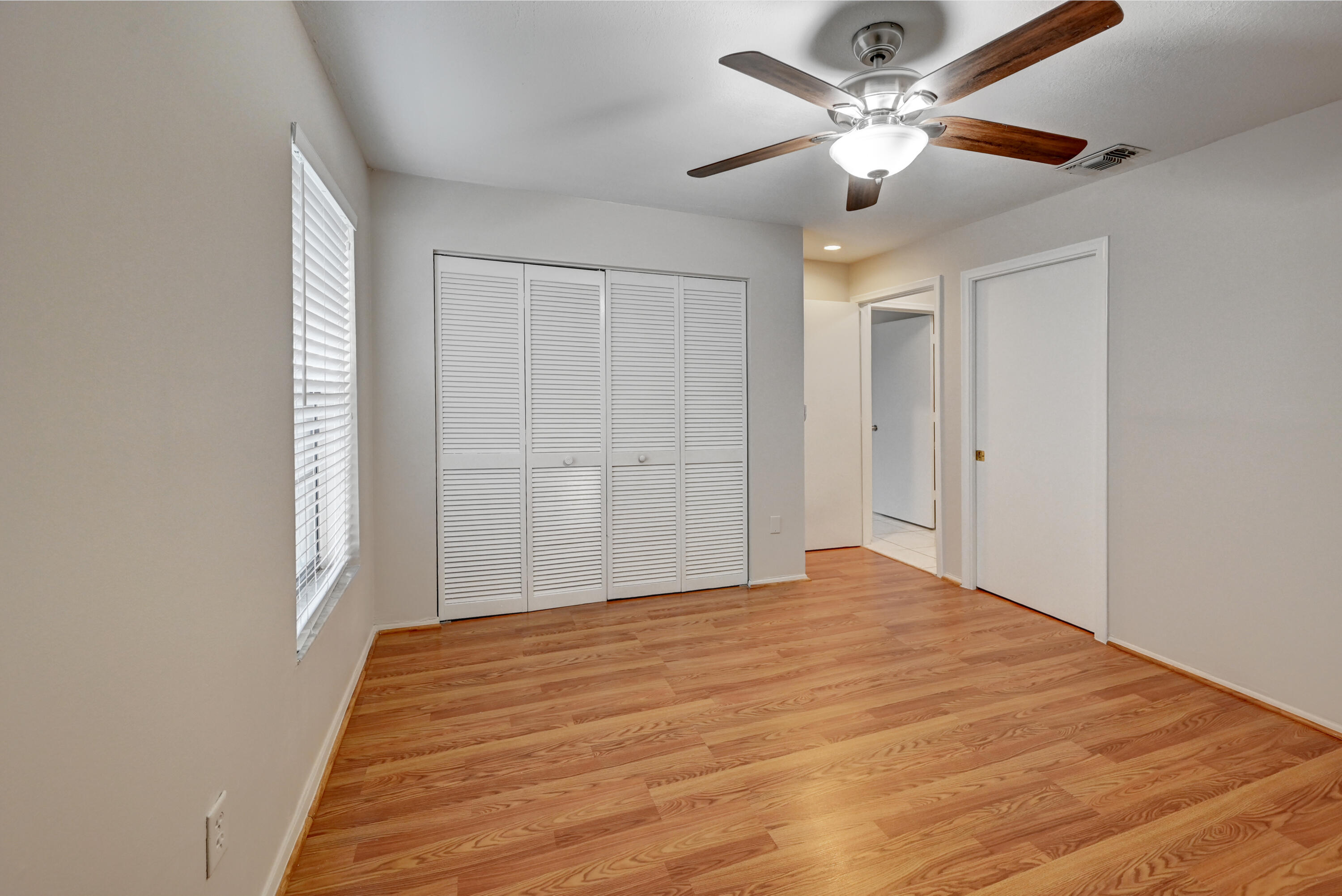 23328 Southwest 58th Avenue, Unit C Boca Raton, FL 33428 - Photo 23 of 35 a bedroom with a bed and a chandelier