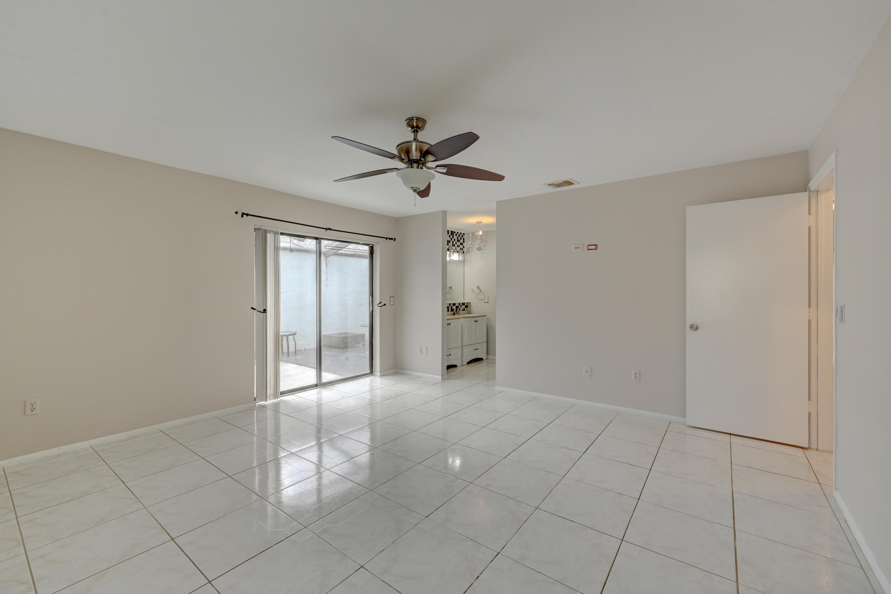 23328 Southwest 58th Avenue, Unit C Boca Raton, FL 33428 - Photo 28 of 35 a view of an empty room with a ceiling fan