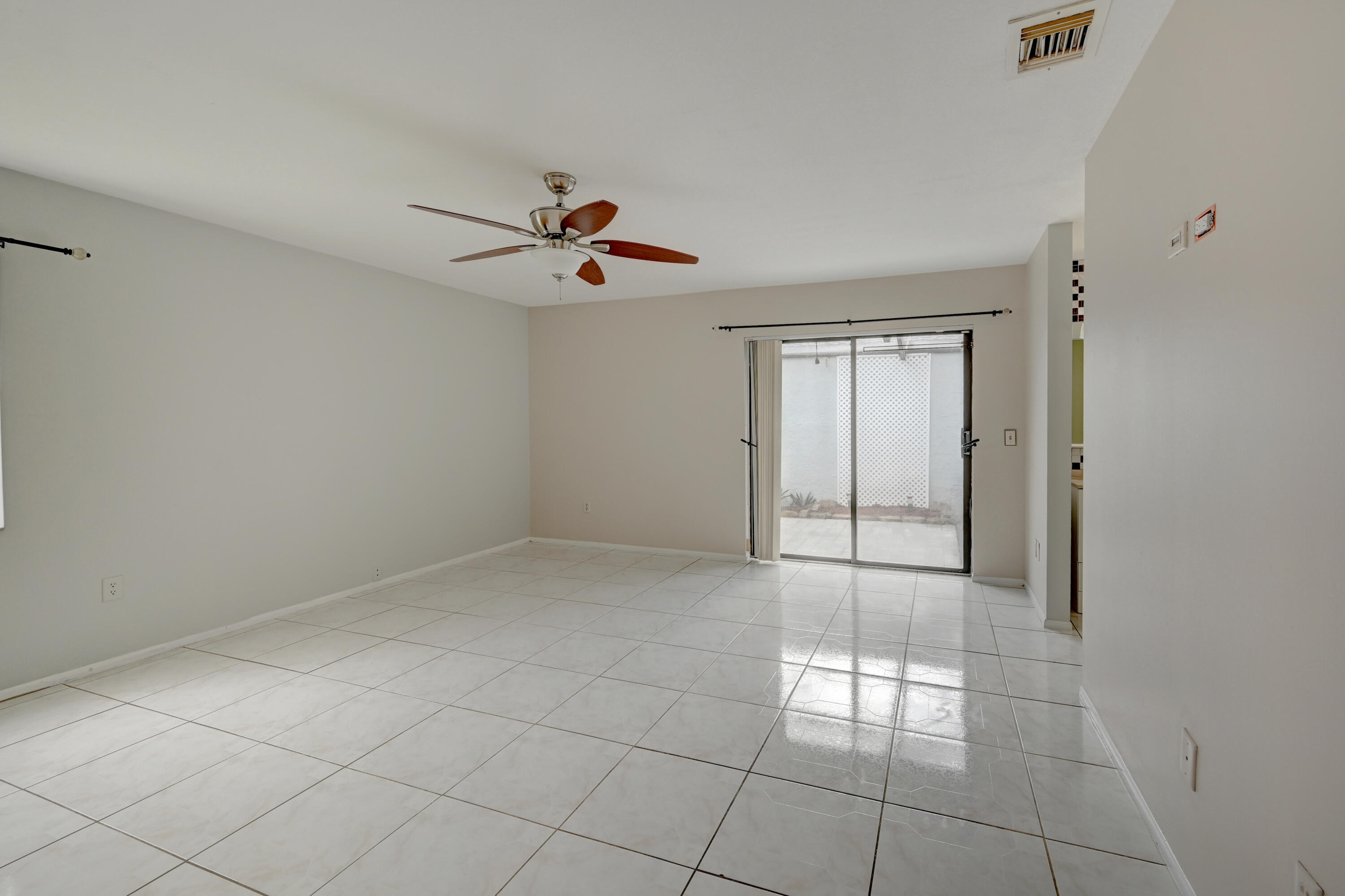 23328 Southwest 58th Avenue, Unit C Boca Raton, FL 33428 - Photo 29 of 35 a view of an empty room with a window