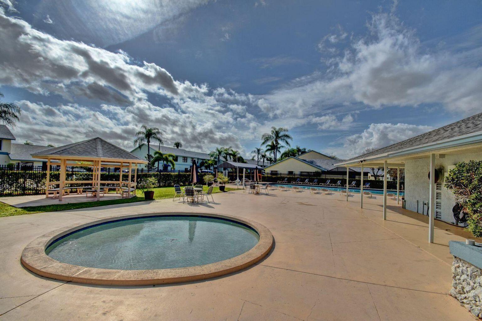 23328 Southwest 58th Avenue, Unit C Boca Raton, FL 33428 - Photo 34 of 35 a view of a swimming pool is middle in the middle of a building