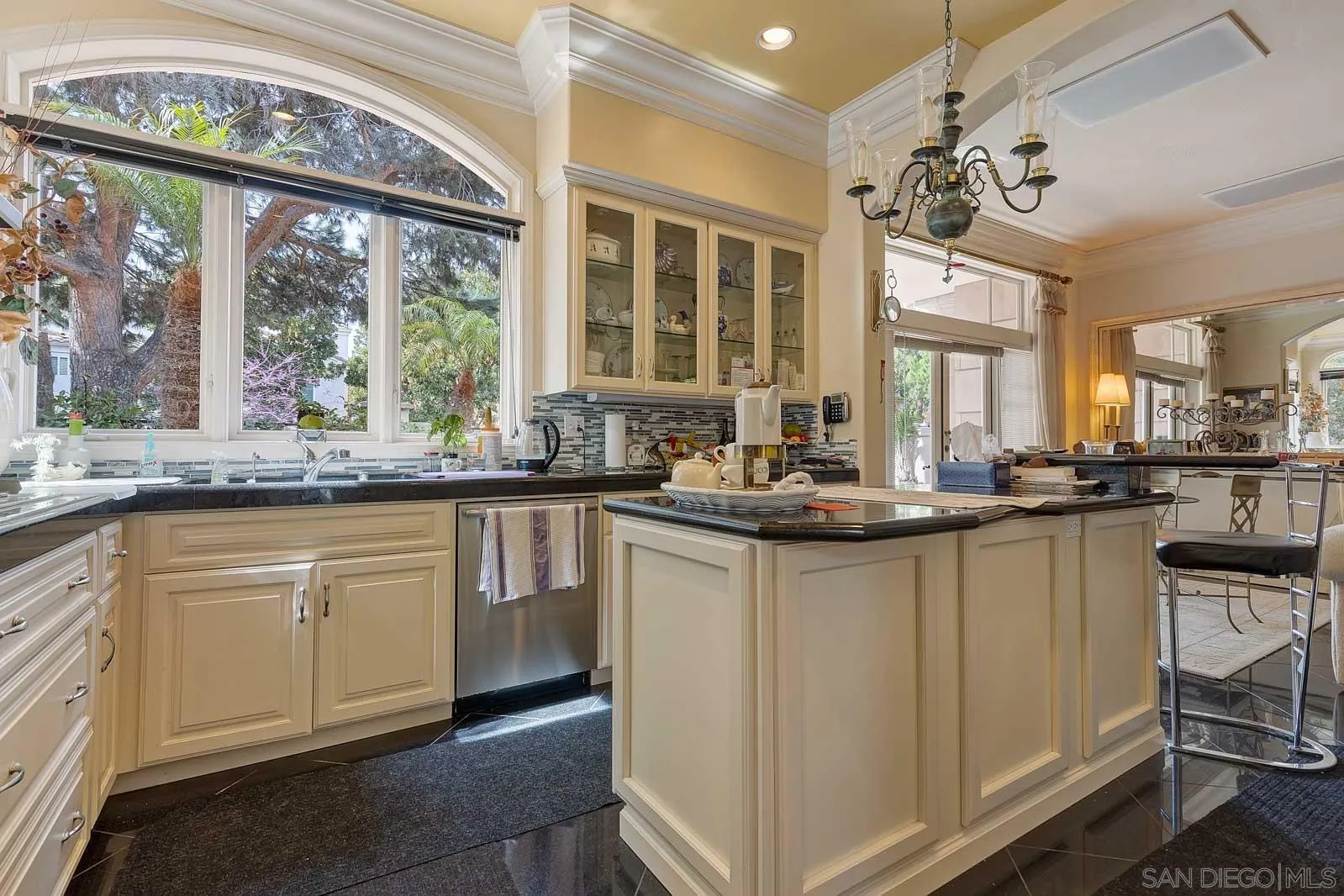 5448 Renaissance Avenue San Diego, CA 92122 - Photo 14 of 35 a kitchen with stainless steel appliances granite countertop white cabinets and a large window