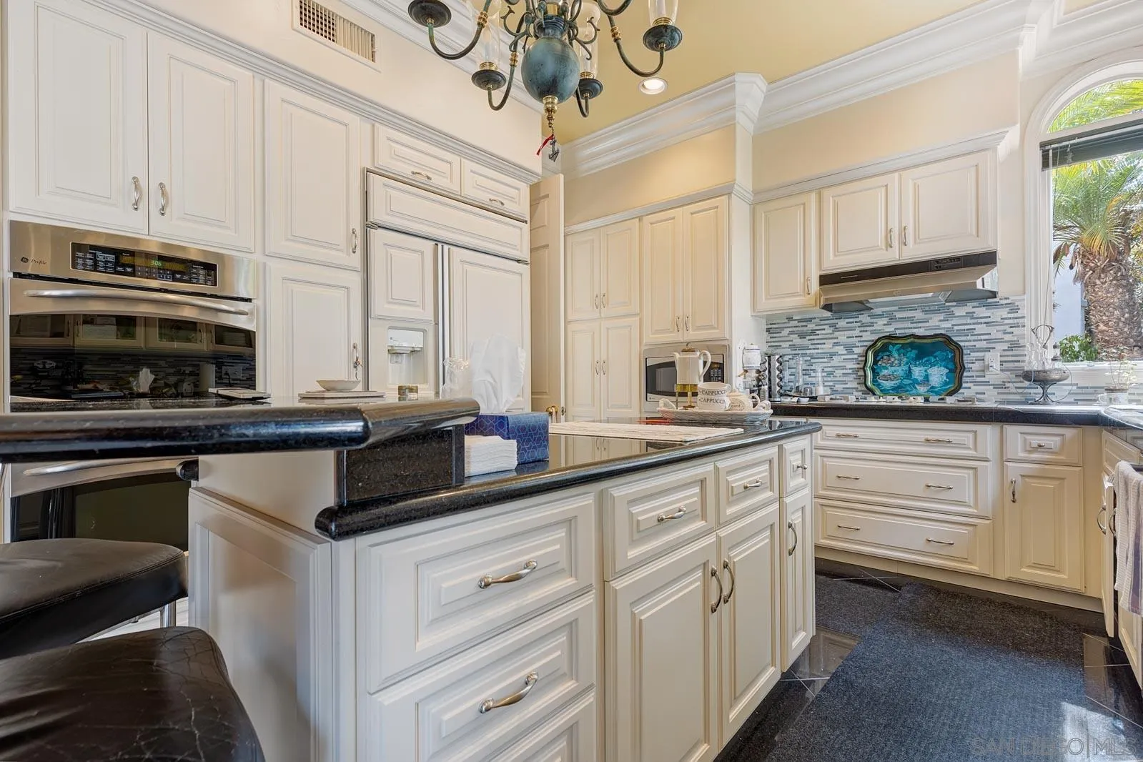 5448 Renaissance Avenue San Diego, CA 92122 - Photo 16 of 35 a kitchen with stainless steel appliances granite countertop a stove a sink and a microwave