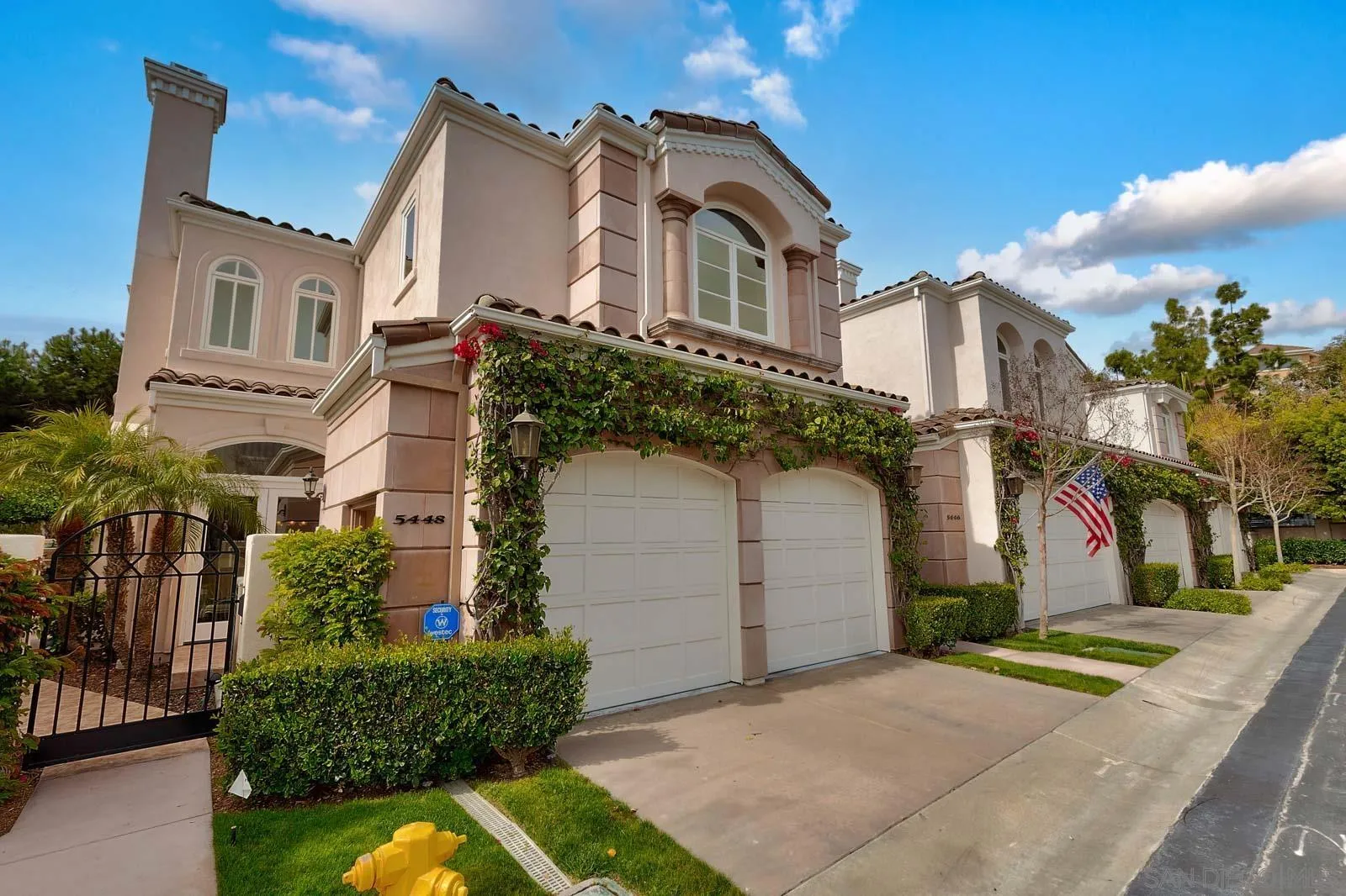 5448 Renaissance Avenue San Diego, CA 92122 - Photo 2 of 35 a front view of a house with a yard and garage