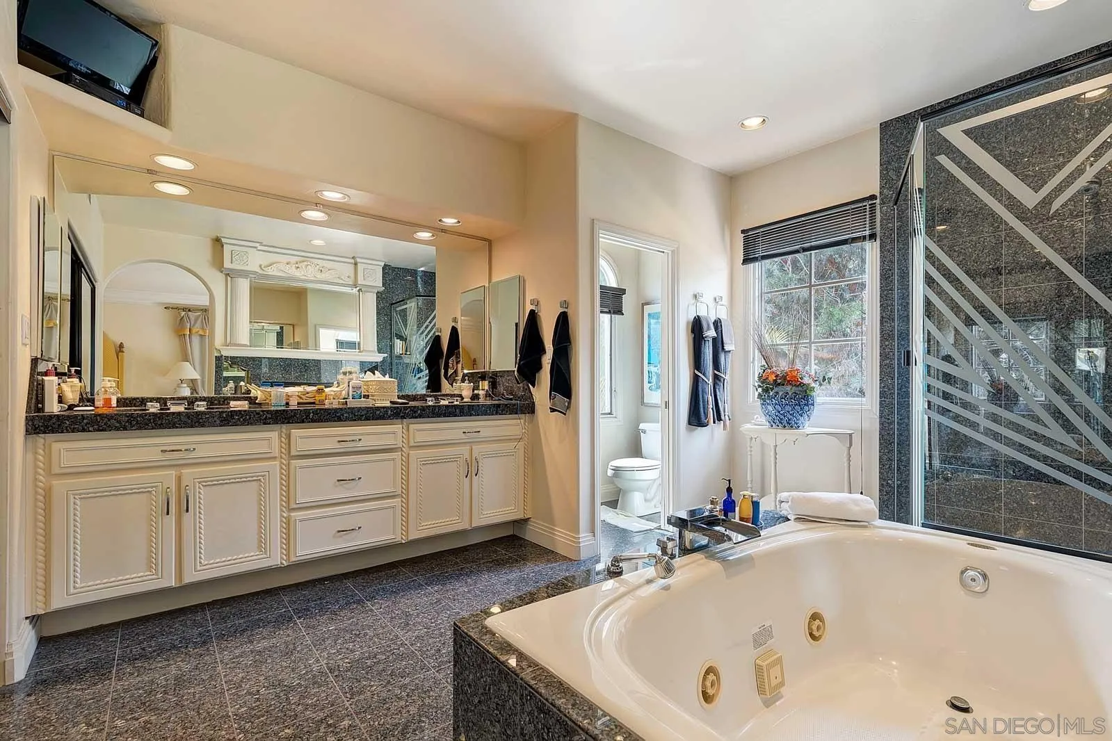 5448 Renaissance Avenue San Diego, CA 92122 - Photo 22 of 35 a bathroom with a bathtub and a sink