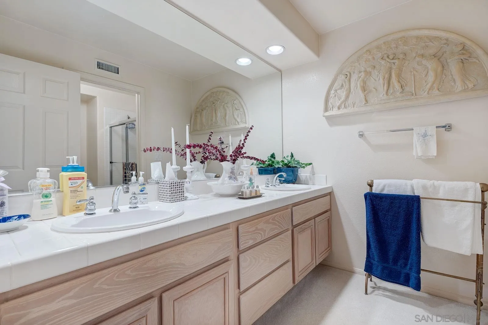 5448 Renaissance Avenue San Diego, CA 92122 - Photo 29 of 35 a bathroom with a double vanity sink and a mirror