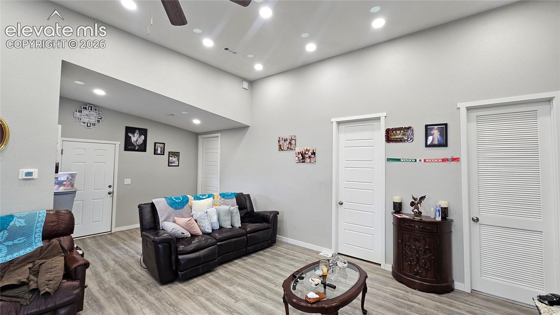 3835 Sengbeil Road Yoder, CO 80864 - Photo 33 of 48 Spacious living area featuring light gray walls, wood-finish flooring, and recessed lighting
