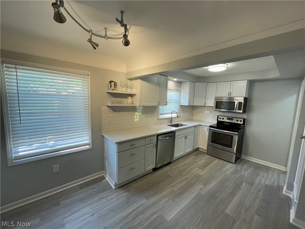 14516 Rockside Road Maple Heights, OH 44137 - Photo 5 of 30 Kitchen featuring wood-type flooring, a wealth of natural light, and appliances with stainless steel finishes