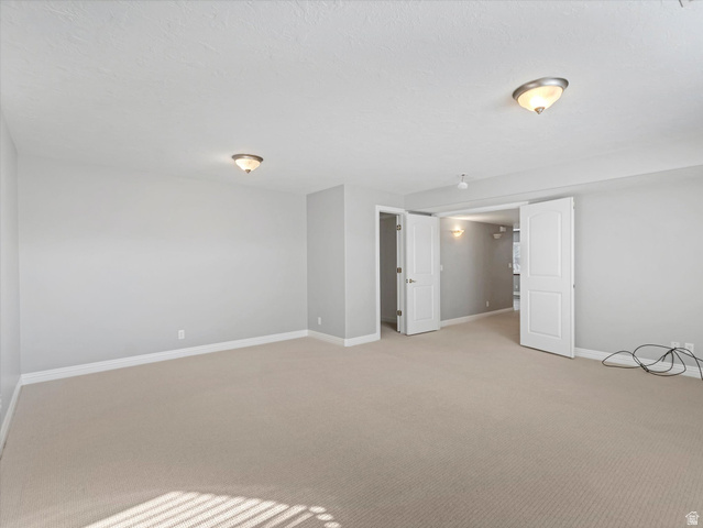 352 Haven Crest Road Draper, UT 84020 - Photo 18 of 44 Expansive room featuring neutral-toned carpeting, light gray wall paint, and white baseboards