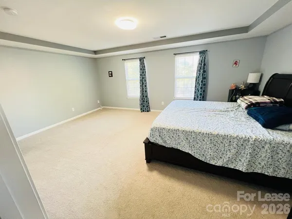 a bedroom with a bed and a couch