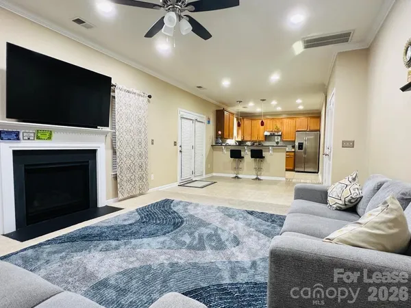 a living room with a fireplace and a flat screen tv