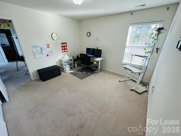 a view of a livingroom with furniture and a window