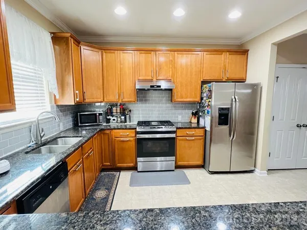 a kitchen with a stove a sink and a refrigerator