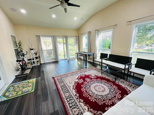 a living room with furniture rug and window