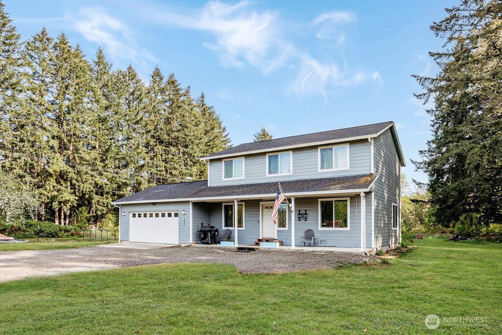a view of a house with a yard and sitting area