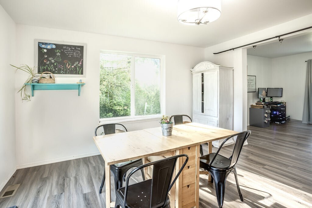 105 Johnson Road South Winlock, WA 98596 - Photo 11 of 32 a view of a dining room with furniture window and wooden floor