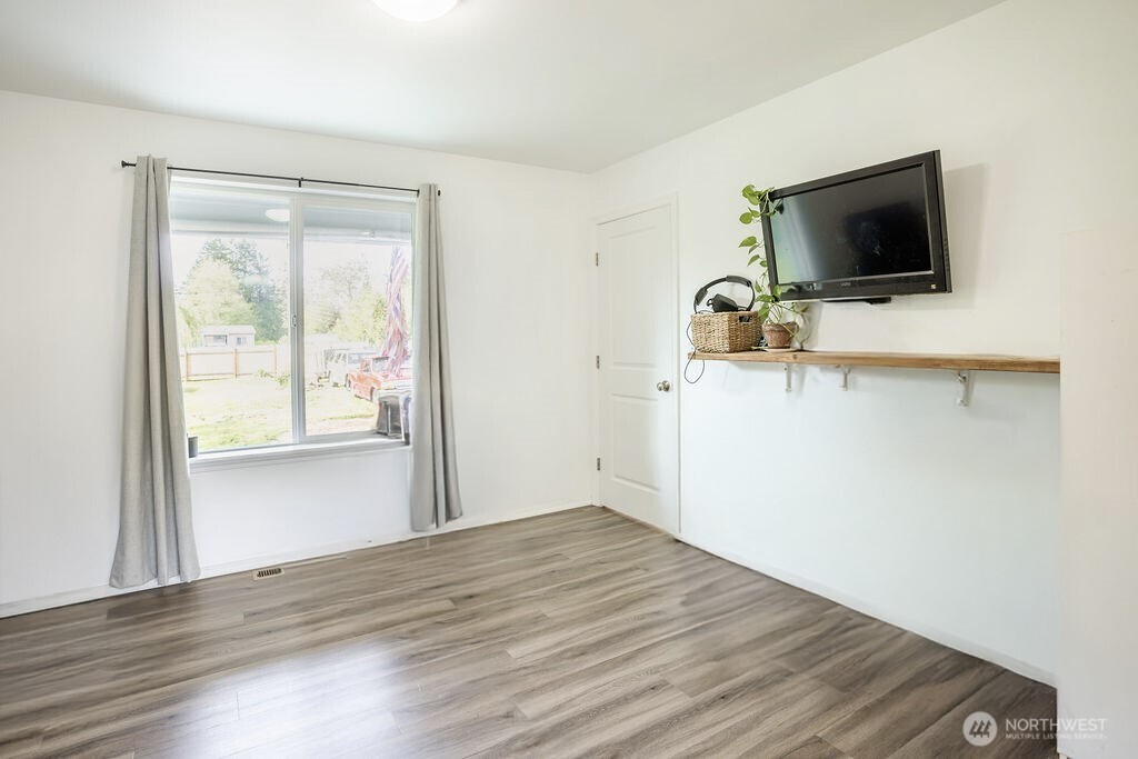 105 Johnson Road South Winlock, WA 98596 - Photo 12 of 32 a view of a livingroom with wooden floor and a flat screen tv