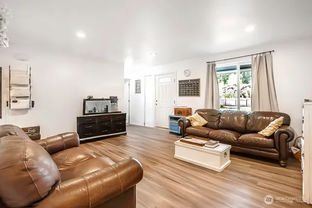 a living room with furniture windows and a flat screen tv