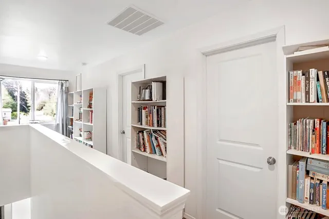 a living room with lots of furniture and a book shelf