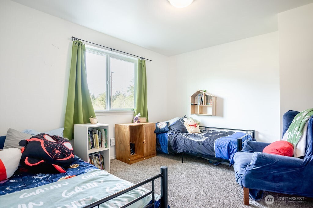 105 Johnson Road South Winlock, WA 98596 - Photo 23 of 32 a bedroom with furniture and a window