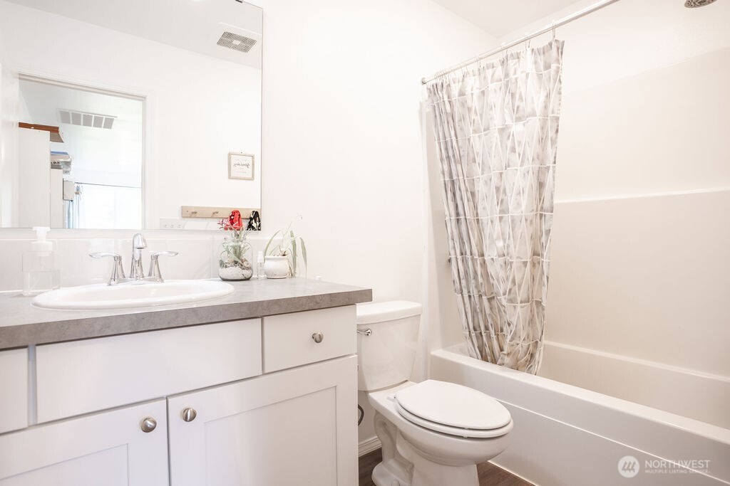 105 Johnson Road South Winlock, WA 98596 - Photo 24 of 32 a bathroom with a sink a toilet and a mirror