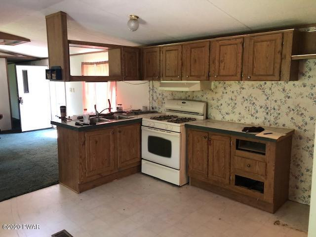 213 Slish Road Honesdale, PA 18431 - Photo 7 of 13 a kitchen with stainless steel appliances granite countertop a stove a sink and a microwave